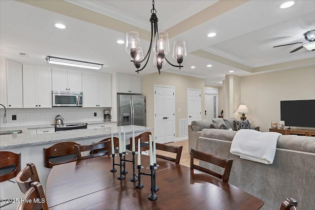 240 Cochrane Castle Cir Unit F, Pinehurst, NC 28374 - dining area featuring ornamental molding, recessed lighting, a ceiling fan, wood finished floors, and a chandelier