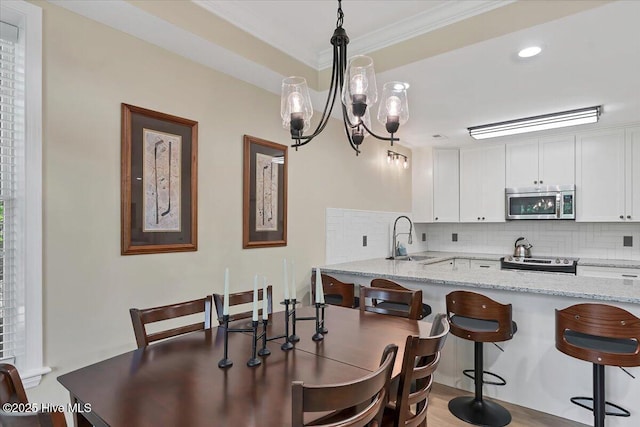240 Cochrane Castle Cir Unit F, Pinehurst, NC 28374 - dining space featuring ornamental molding, a chandelier, and recessed lighting