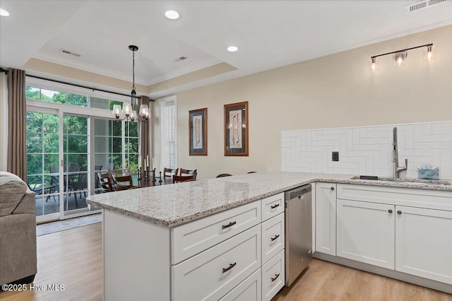 240 Cochrane Castle Cir Unit F, Pinehurst, NC 28374 - kitchen featuring stainless steel dishwasher, a chandelier, light wood-style floors, white cabinetry, and tasteful backsplash