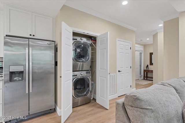 240 Cochrane Castle Cir Unit F, Pinehurst, NC 28374 - laundry room featuring stacked washer / drying machine, crown molding, light wood-style flooring, and recessed lighting