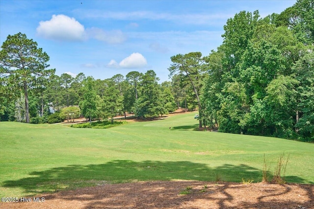 240 Cochrane Castle Cir Unit F, Pinehurst, NC 28374 - view of community featuring view of golf course, a lawn, and view of wooded area