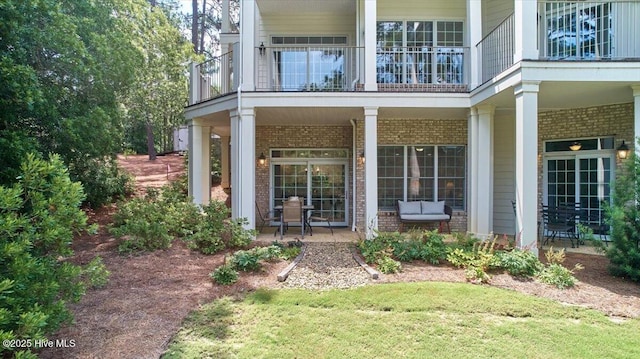 240 Cochrane Castle Cir Unit F, Pinehurst, NC 28374 - doorway to property with brick siding, a balcony, and covered porch