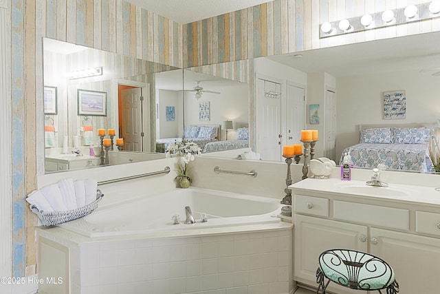 330 S Middleton Dr NW Unit 1009, Calabash, NC 28467 - bathroom with ensuite bath, ceiling fan, wallpapered walls, a garden tub, and vanity