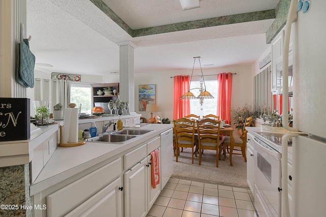 330 S Middleton Dr NW Unit 1009, Calabash, NC 28467 - kitchen with white appliances, a textured ceiling, light carpet, plenty of natural light, and light countertops