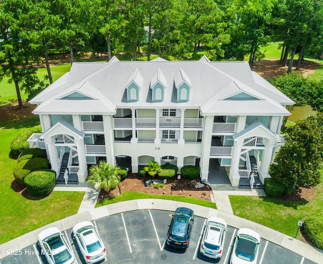 330 S Middleton Dr NW Unit 1009, Calabash, NC 28467 - view of property with uncovered parking, stairs, and view of scattered trees