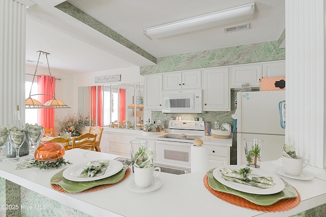 330 S Middleton Dr NW Unit 1009, Calabash, NC 28467 - kitchen featuring white appliances, a textured ceiling, white cabinets, and light countertops