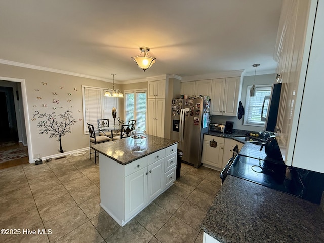2834 Lancaster Rd NW, Wilson, NC 27896 - kitchen featuring stainless steel fridge, ornamental molding, white cabinetry, a chandelier, and tile patterned floors