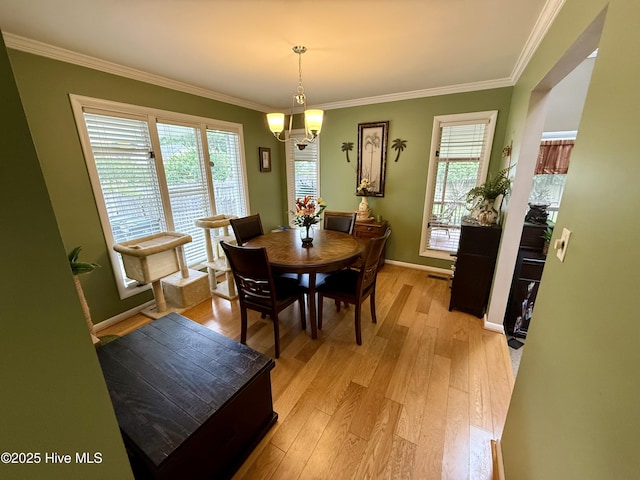 2834 Lancaster Rd NW, Wilson, NC 27896 - dining space with light wood finished floors, healthy amount of natural light, ornamental molding, and a chandelier