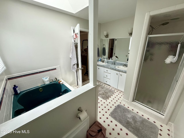 2834 Lancaster Rd NW, Wilson, NC 27896 - full bathroom featuring a shower stall, a garden tub, double vanity, and a skylight