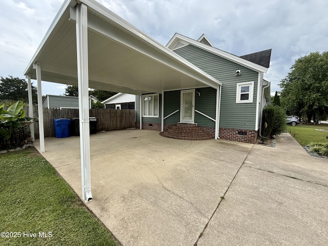 2834 Lancaster Rd NW, Wilson, NC 27896 - view of side of home featuring concrete driveway, crawl space, roof with shingles, and a carport