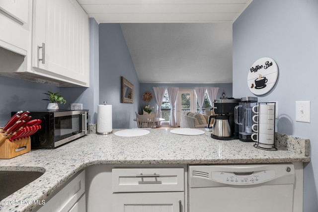 6227 Harbourside Dr, New Bern, NC 28560 - kitchen with white dishwasher, white cabinetry, lofted ceiling, stainless steel microwave, and light stone countertops