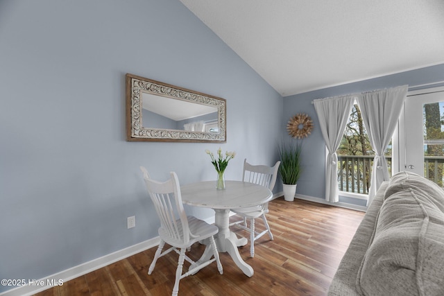 6227 Harbourside Dr, New Bern, NC 28560 - dining room featuring lofted ceiling and wood finished floors