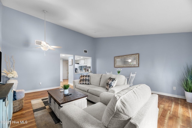 6227 Harbourside Dr, New Bern, NC 28560 - living area featuring light wood finished floors, vaulted ceiling, and a ceiling fan
