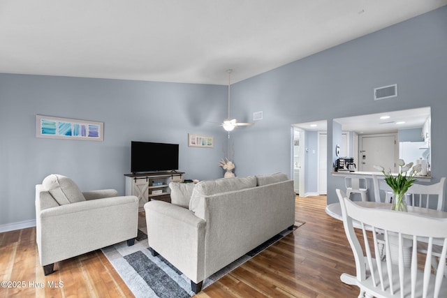 6227 Harbourside Dr, New Bern, NC 28560 - living room with wood finished floors, a ceiling fan, and a towering ceiling