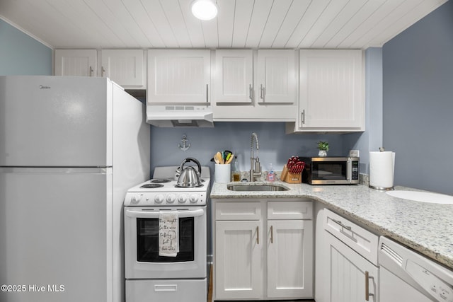 6227 Harbourside Dr, New Bern, NC 28560 - kitchen with white appliances, under cabinet range hood, white cabinets, wooden ceiling, and light stone counters