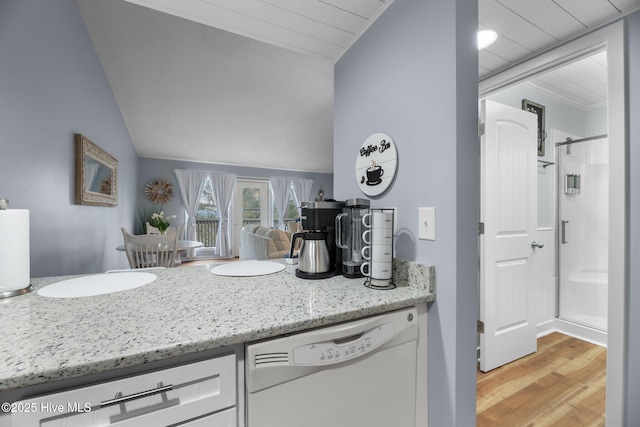 6227 Harbourside Dr, New Bern, NC 28560 - kitchen with dishwasher, white cabinets, lofted ceiling, light wood-type flooring, and light stone counters