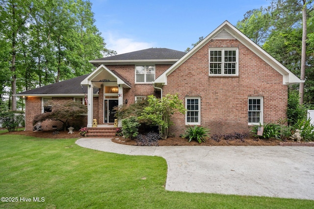 6122 Timber Creek Ln, Wilmington, NC 28411 - view of front of home with a front lawn, brick siding, and a shingled roof