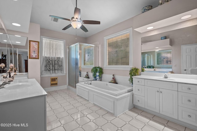 6122 Timber Creek Ln, Wilmington, NC 28411 - bathroom with a ceiling fan, two vanities, a stall shower, a bath, and heating unit