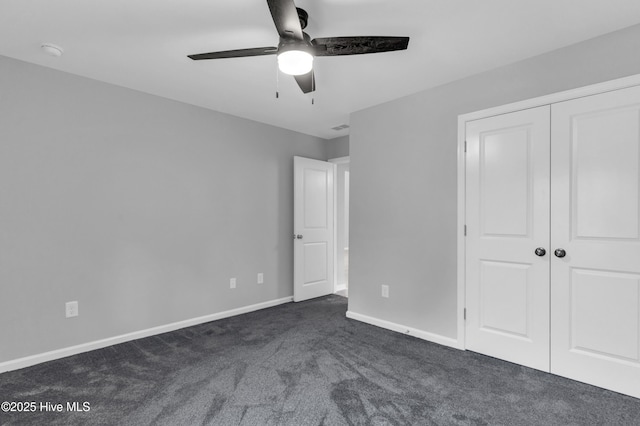 6468 Merceron St SW, Ocean Isle Beach, NC 28469 - unfurnished bedroom with dark colored carpet, a closet, and a ceiling fan