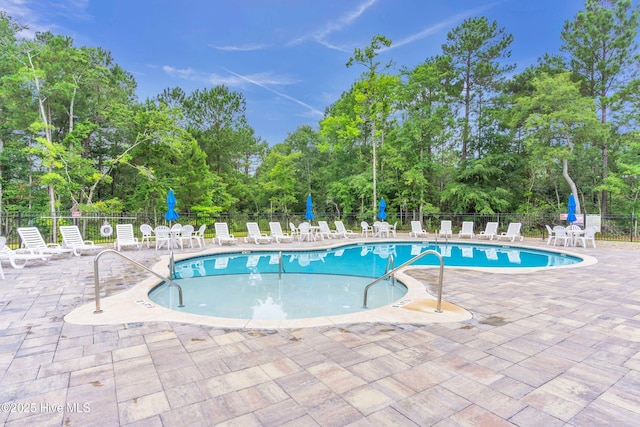 6468 Merceron St SW, Ocean Isle Beach, NC 28469 - community pool with a patio and view of scattered trees