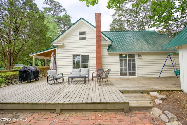 615 E Main St, Aberdeen, NC 28315 - back of property with a chimney, an outdoor hangout area, a deck, and a metal roof