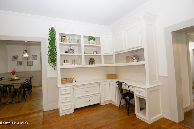 615 E Main St, Aberdeen, NC 28315 - home office with built in desk, dark wood-style floors, wainscoting, and crown molding