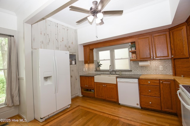 615 E Main St, Aberdeen, NC 28315 - kitchen with white appliances, brown cabinets, ornamental molding, a ceiling fan, and light wood-style flooring