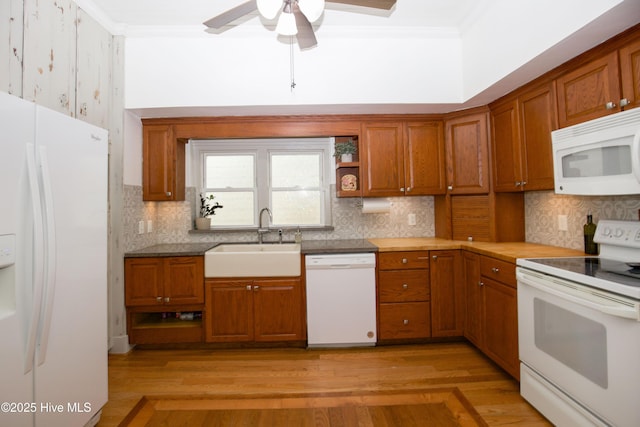 615 E Main St, Aberdeen, NC 28315 - kitchen featuring white appliances, crown molding, brown cabinets, a ceiling fan, and tasteful backsplash