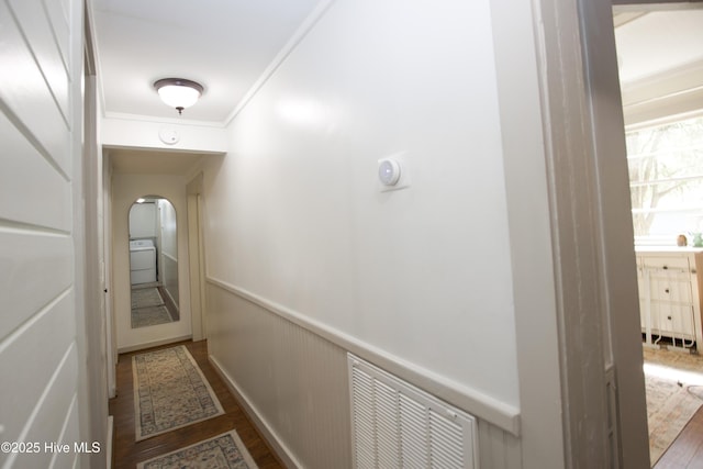 615 E Main St, Aberdeen, NC 28315 - hallway featuring wood finished floors, wainscoting, crown molding, and arched walkways