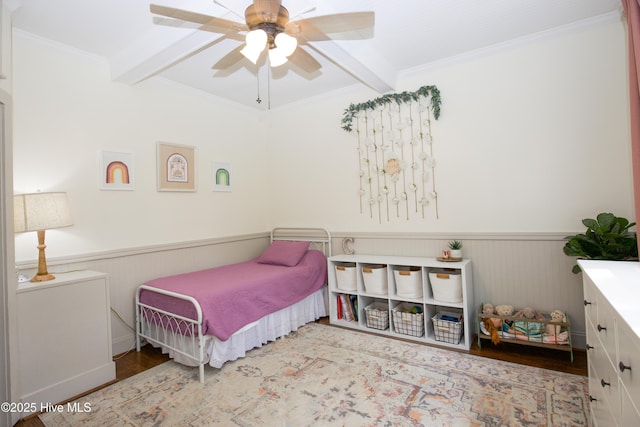 615 E Main St, Aberdeen, NC 28315 - bedroom with beam ceiling, wainscoting, wood finished floors, ornamental molding, and ceiling fan