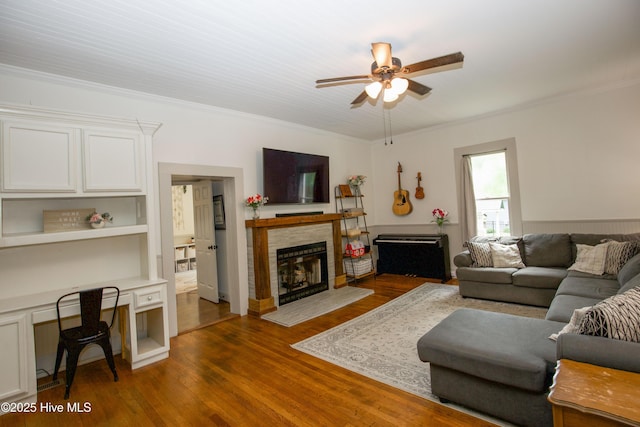 615 E Main St, Aberdeen, NC 28315 - living room featuring a ceiling fan, a fireplace, ornamental molding, wood finished floors, and an office area