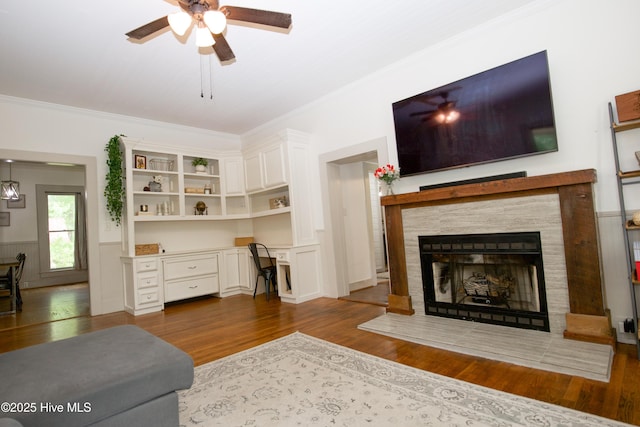 615 E Main St, Aberdeen, NC 28315 - living area with dark wood-style flooring, ceiling fan, crown molding, built in study area, and a tile fireplace