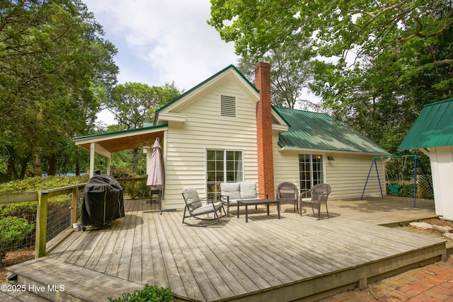 615 E Main St, Aberdeen, NC 28315 - back of property featuring a deck, an outdoor hangout area, a chimney, and a metal roof