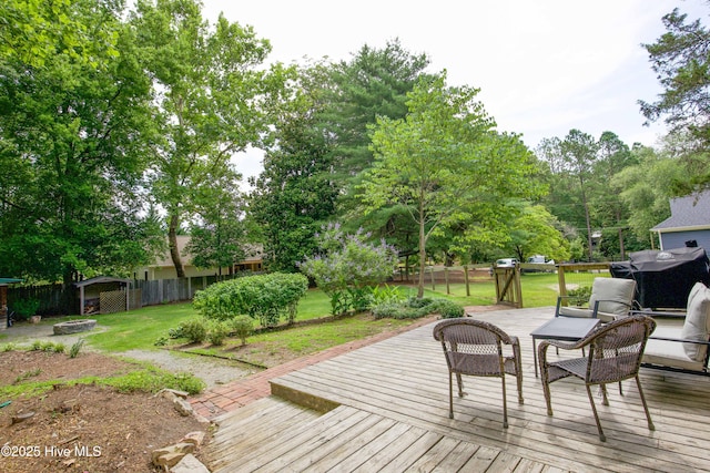 615 E Main St, Aberdeen, NC 28315 - wooden terrace featuring a fenced backyard, a grill, and view of wooded area
