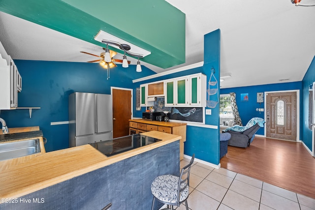 608 Calabash Dr, Hubert, NC 28539 - kitchen with freestanding refrigerator, light tile patterned floors, black electric cooktop, a ceiling fan, and wood counters