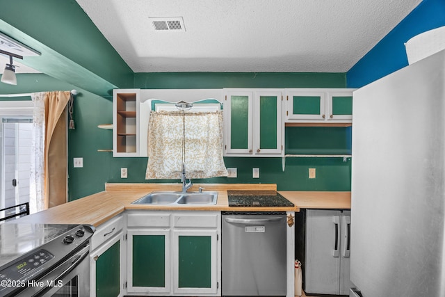 608 Calabash Dr, Hubert, NC 28539 - kitchen with stainless steel appliances, open shelves, a textured ceiling, and light countertops