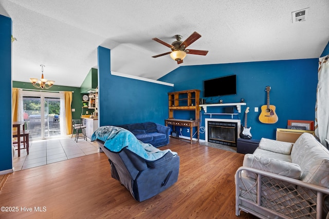 608 Calabash Dr, Hubert, NC 28539 - living area featuring a chandelier, lofted ceiling, a textured ceiling, a ceiling fan, and wood finished floors