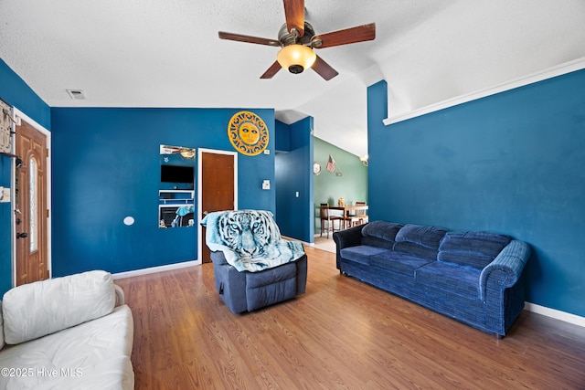 608 Calabash Dr, Hubert, NC 28539 - living room with ceiling fan, lofted ceiling, wood finished floors, and a textured ceiling