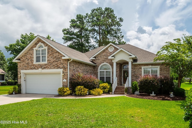 1045 Edenton Dr NW, Calabash, NC 28467 - view of front of home featuring roof with shingles, a front yard, driveway, and brick siding