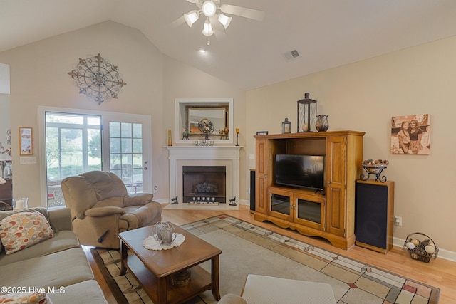 1045 Edenton Dr NW, Calabash, NC 28467 - living room with a ceiling fan, a fireplace with flush hearth, light wood-style floors, and high vaulted ceiling