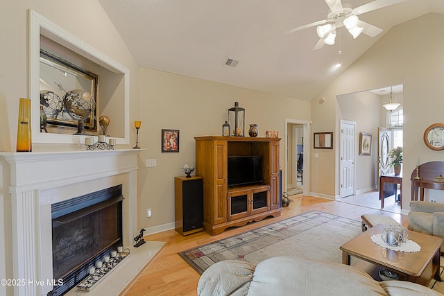 1045 Edenton Dr NW, Calabash, NC 28467 - living room with a ceiling fan, a fireplace with flush hearth, light wood-type flooring, and high vaulted ceiling