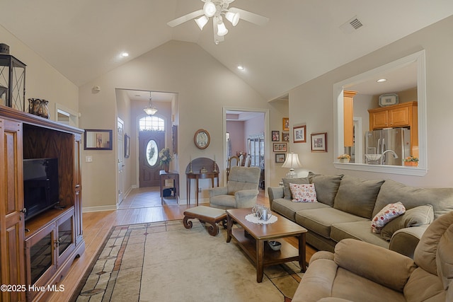 1045 Edenton Dr NW, Calabash, NC 28467 - living room with light wood-style flooring, high vaulted ceiling, a ceiling fan, and recessed lighting