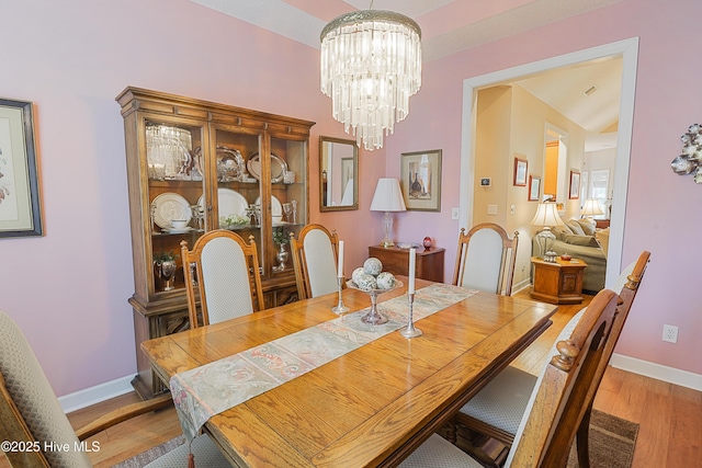 1045 Edenton Dr NW, Calabash, NC 28467 - dining area with wood finished floors and a chandelier