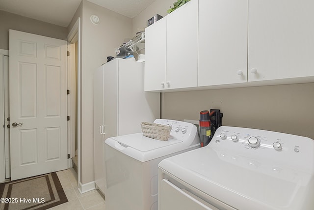 1045 Edenton Dr NW, Calabash, NC 28467 - laundry area with washing machine and clothes dryer, cabinet space, and light tile patterned floors