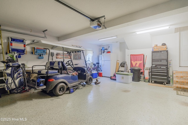 1045 Edenton Dr NW, Calabash, NC 28467 - garage featuring a garage door opener and freestanding refrigerator