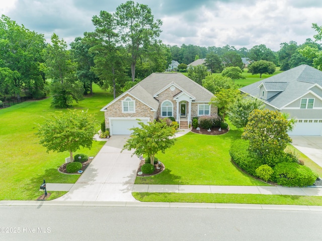1045 Edenton Dr NW, Calabash, NC 28467 - view of front of home with driveway, a front yard, stone siding, and view of wooded area