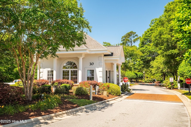 1045 Edenton Dr NW, Calabash, NC 28467 - view of front of house with a shingled roof and stucco siding