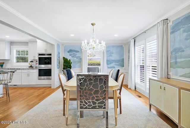 311 Lennox Pl, Wilmington, NC 28412 - dining space featuring crown molding, light wood-style flooring, and a chandelier