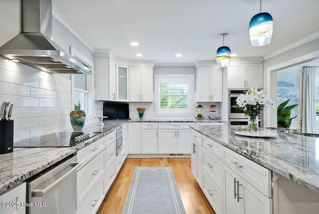 311 Lennox Pl, Wilmington, NC 28412 - kitchen with wall chimney range hood, appliances with stainless steel finishes, white cabinets, crown molding, and light wood finished floors