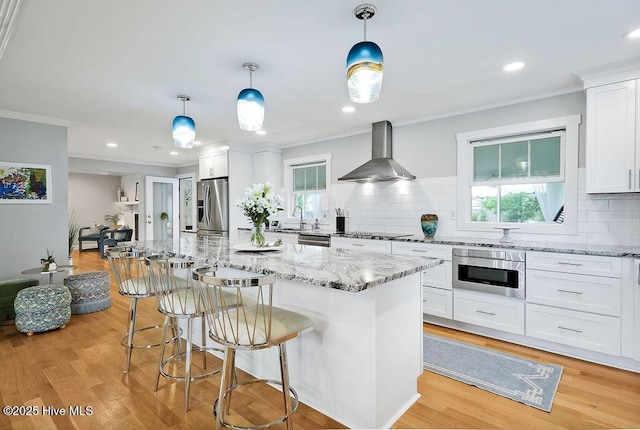 311 Lennox Pl, Wilmington, NC 28412 - kitchen with wall chimney exhaust hood, stainless steel appliances, backsplash, healthy amount of natural light, and crown molding